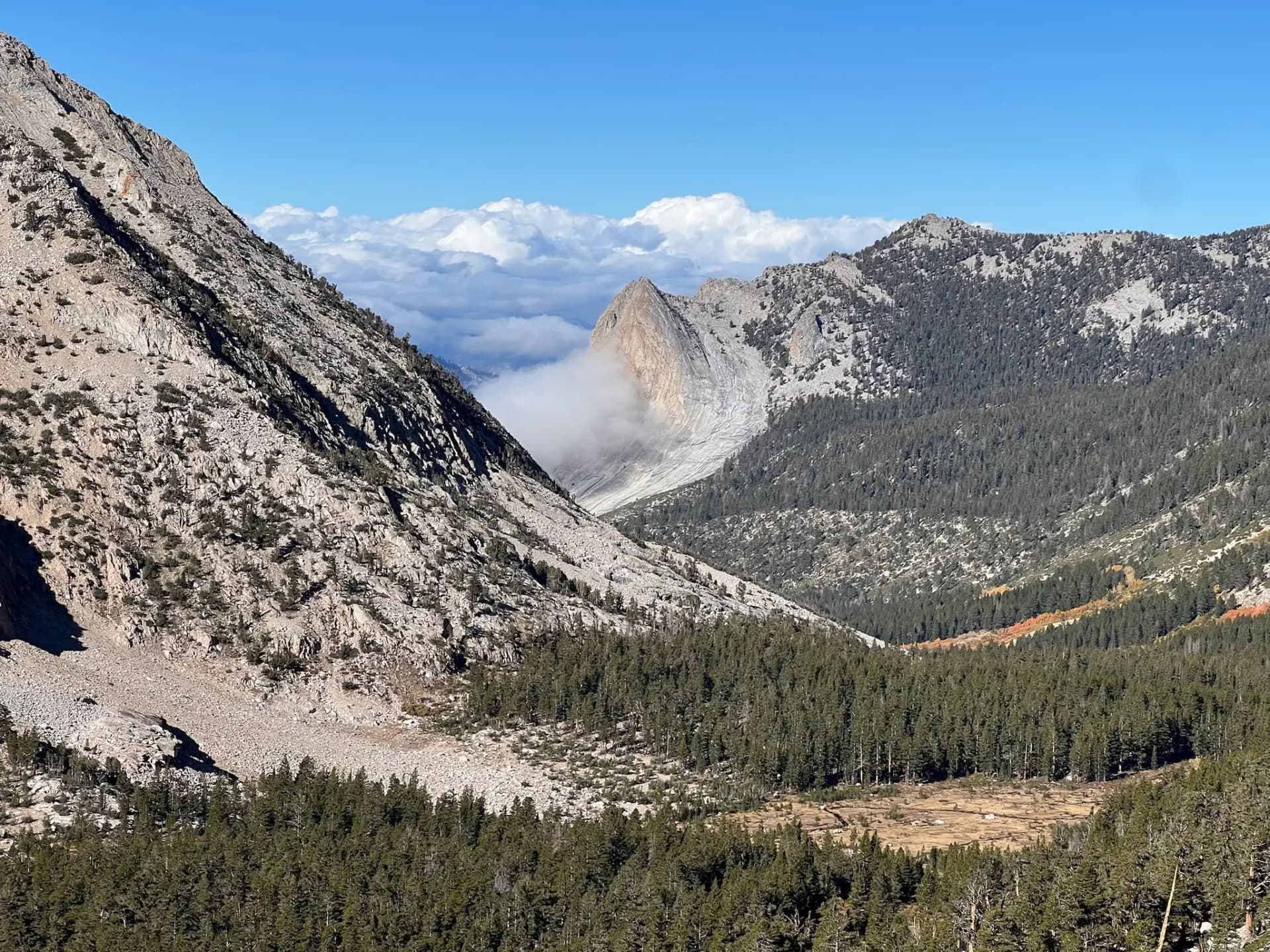 Looking West towards clouds rising through Charlotte Creek.