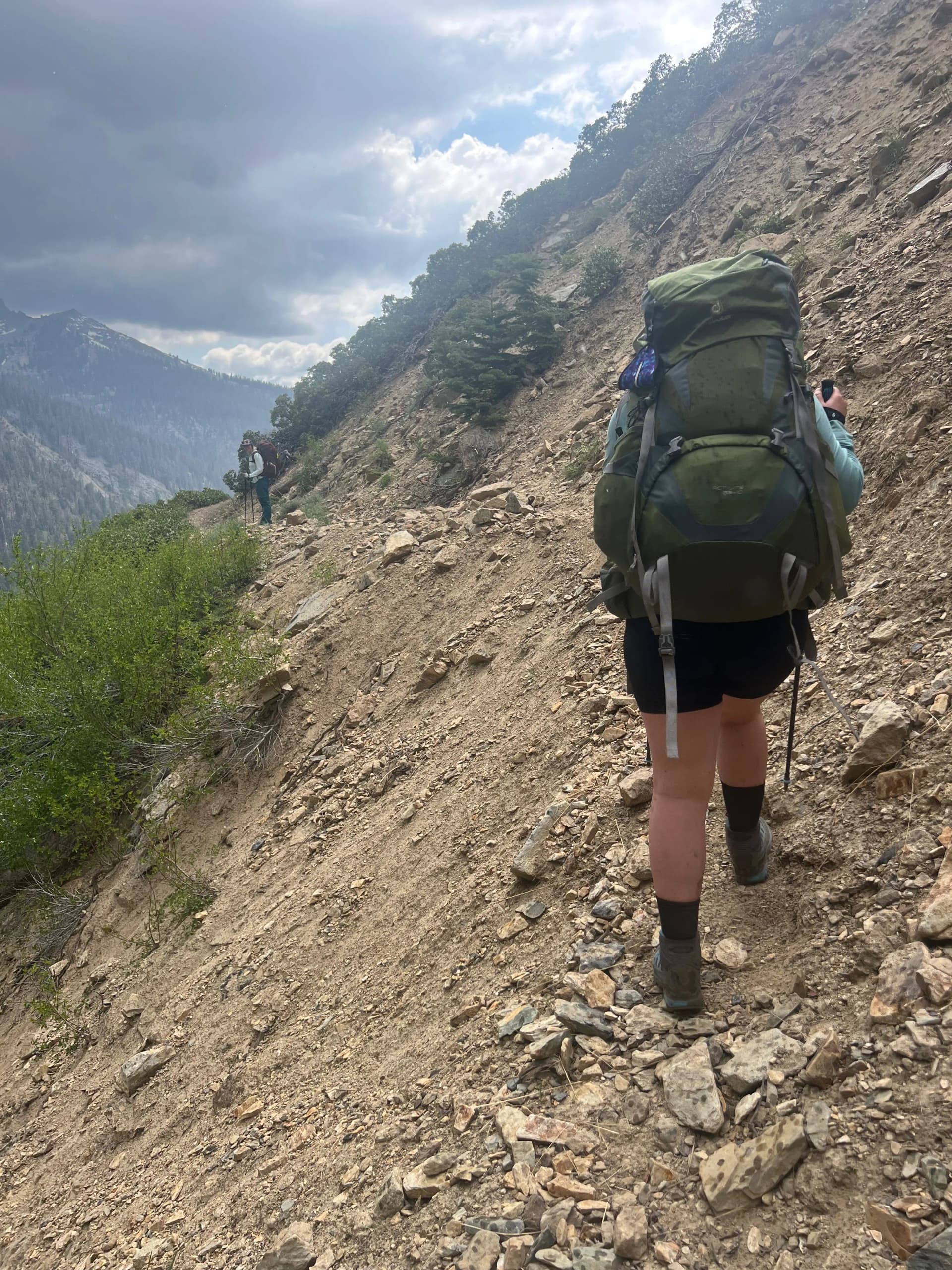 Hiker traverses washed out trail